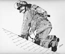 Firefighter crawling on a roof